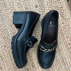 Black heeled loafers with gold chain detail